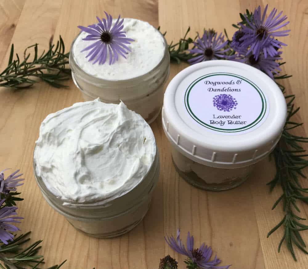 Labeled whipped body butter and two open containers of whipped body butter