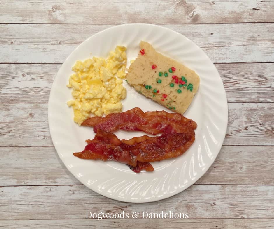 scrambled eggs, bacon, and oven pancakes with Christmas sprinkles