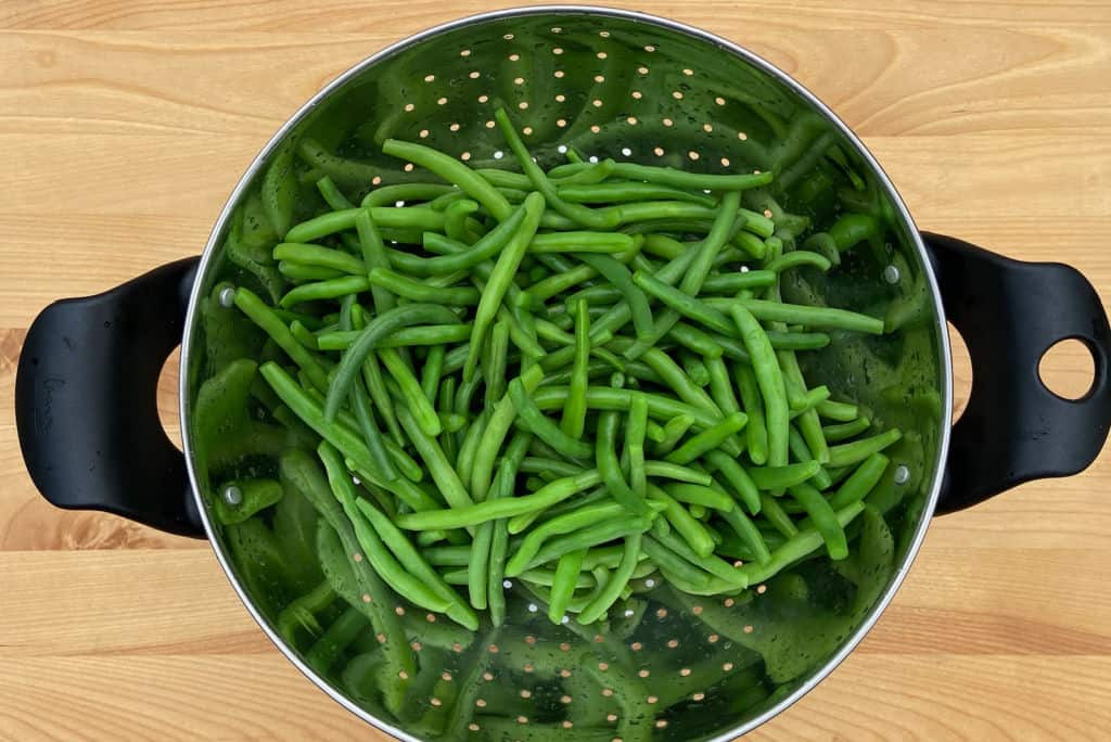 a colander of fresh green beans