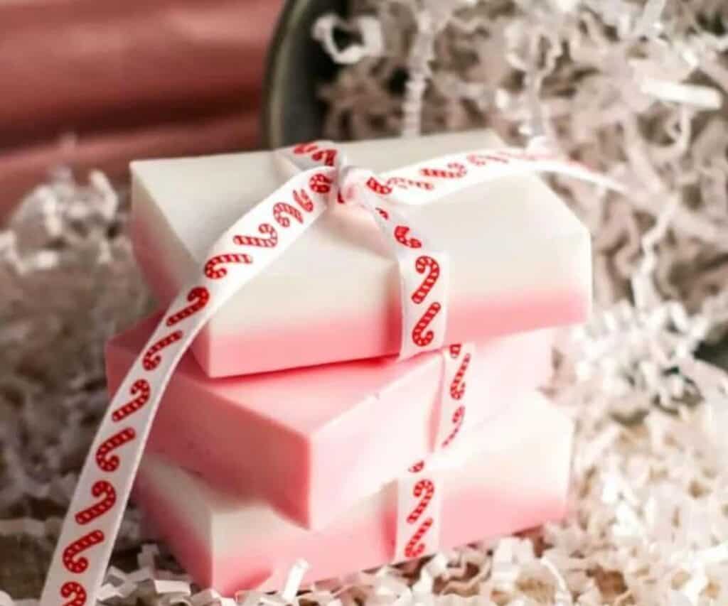 3 bars of peppermint soap with a pink layer on the bottom and white on top.