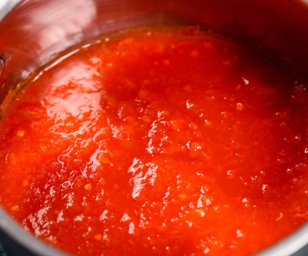 a pot of tomato sauce being cooked down