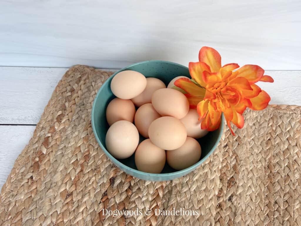a bowl of eggs with an orange flower on top