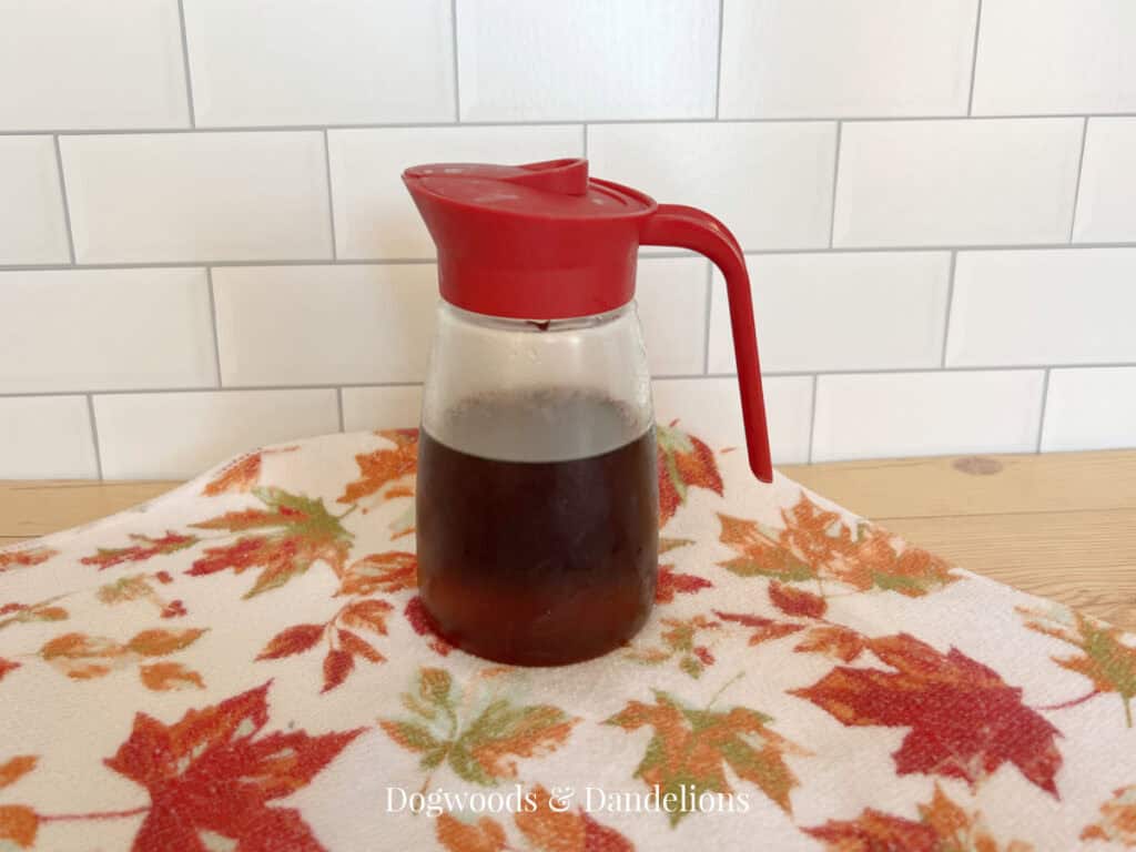 a jar of homemade pancake syrup on a fall towel